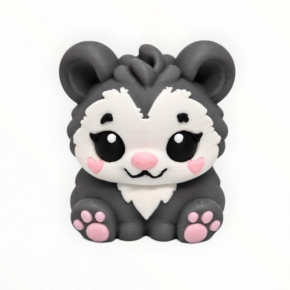 Possum Blossom 3D printed possum bead featuring a cute sitting gray opossum with a white face, large black eyes, pink heart-shaped cheeks, pink nose, oversized ears, and pink paw pads.