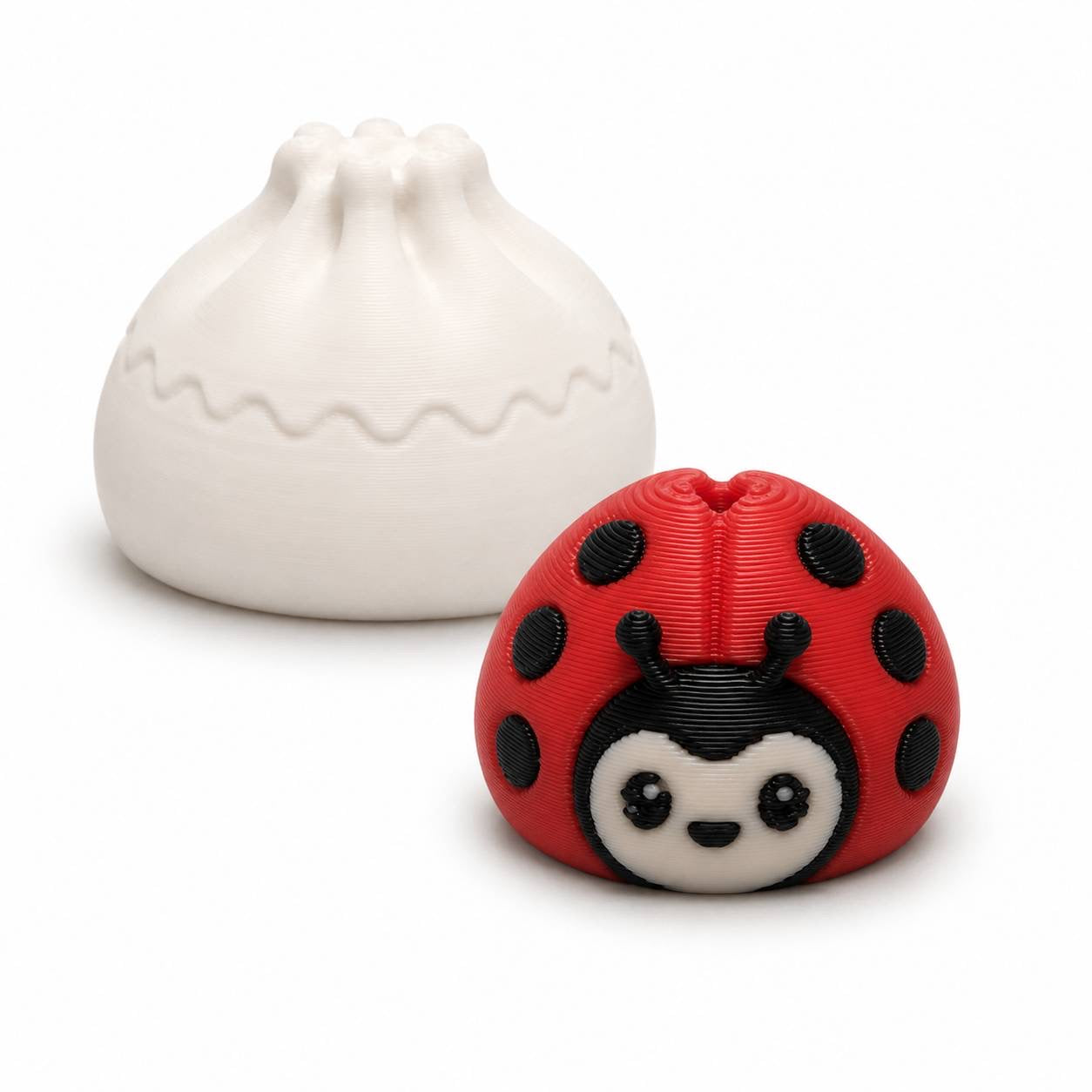 Ladybug Mini Dumpling 22mm 3D printed bead with red body and black spots shown with Original Dumpling for size comparison