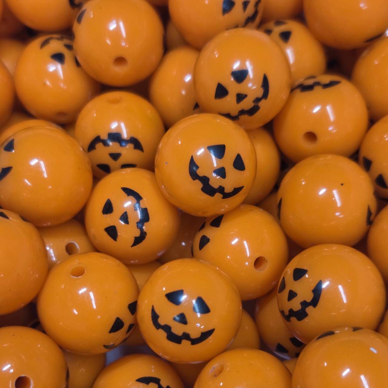 Orange 20mm printed acrylic bead with a black jack-o'-lantern face for Halloween-themed craft projects.