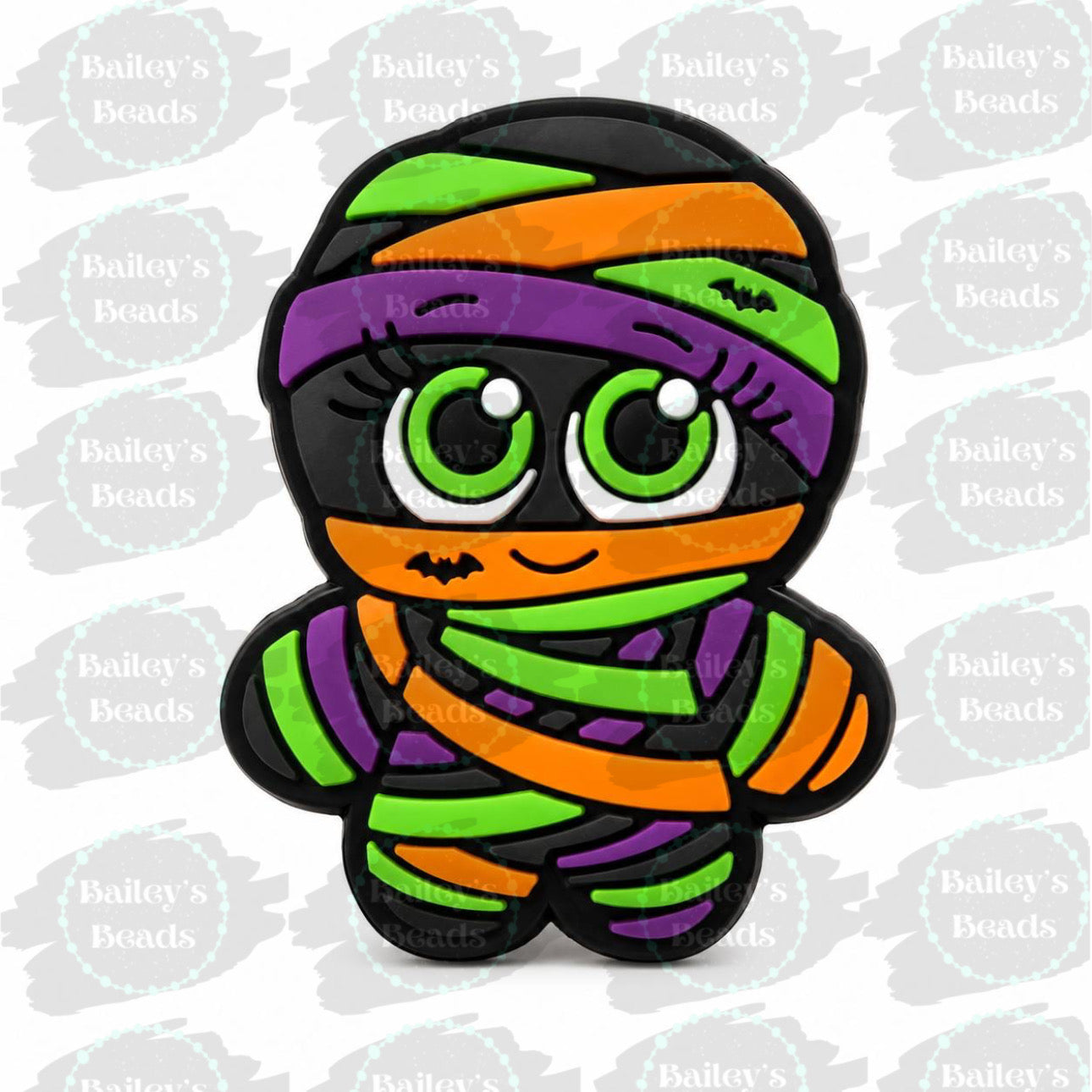 Exclusive Mummy Cutie silicone focal bead featuring an adorable mummy with bright green eyes and colorful Halloween bandages, designed by Bailey's Beads.