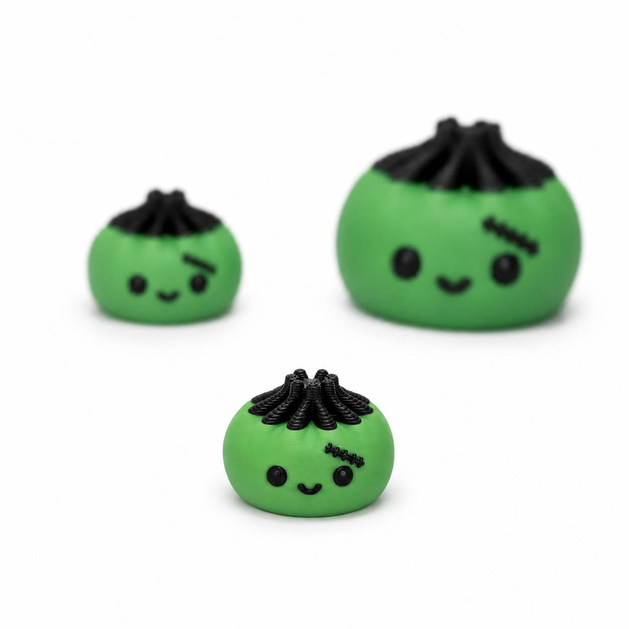 Green Frankie Bitty Dimpling Pen Palz 3D printed bead with black hair, stitched details, and a cute smiling face in an approximately 15mm size.