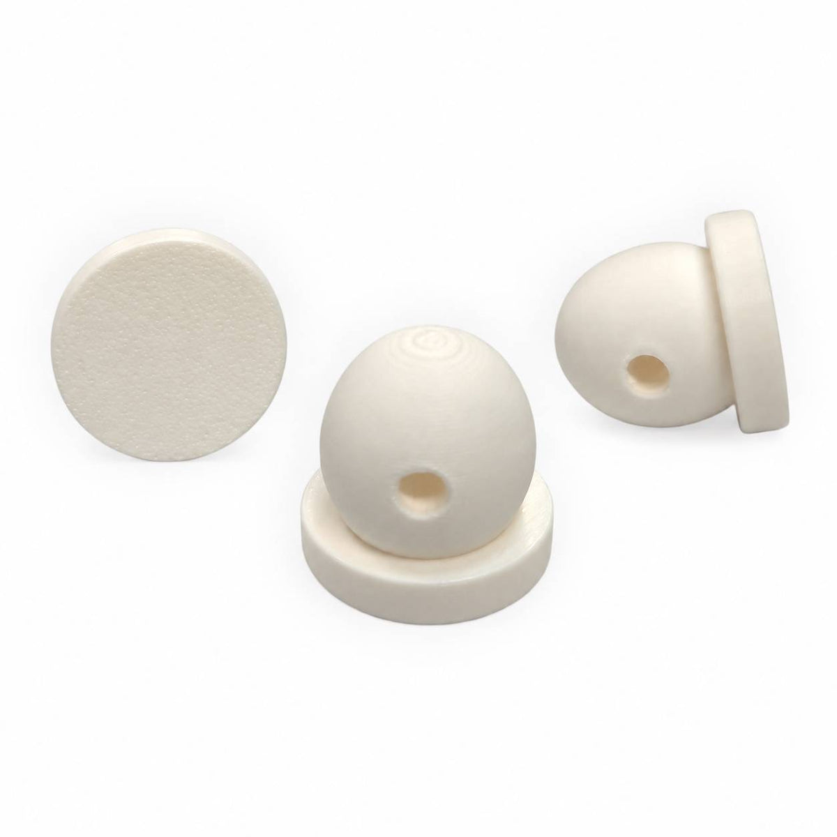 White 3D printed glue-on flatback bead attachments shown from three angles, featuring a flat circular base and rounded bead with a threading hole for DIY acrylic flatback crafts.