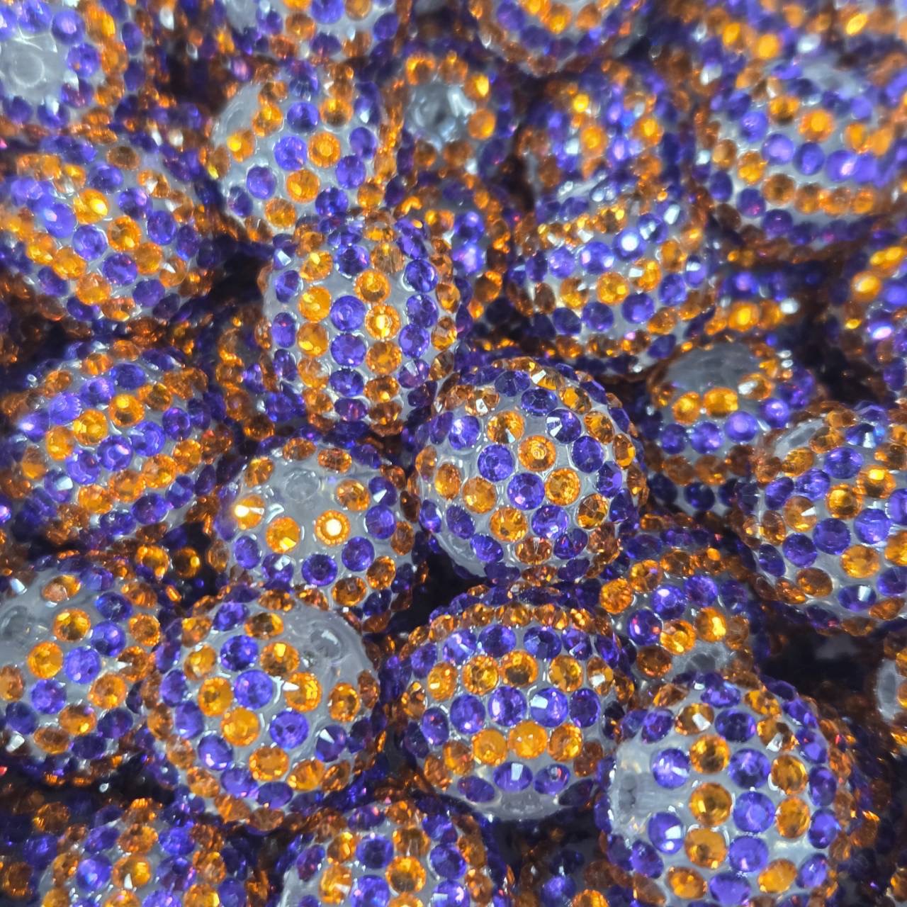 White 20mm acrylic bead with purple and orange rhinestones for Halloween and fall craft projects.