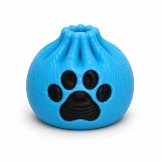 Bright blue Blue Paws Dumpling 3D printed bead with large black paw print by Bailey’s Beads.