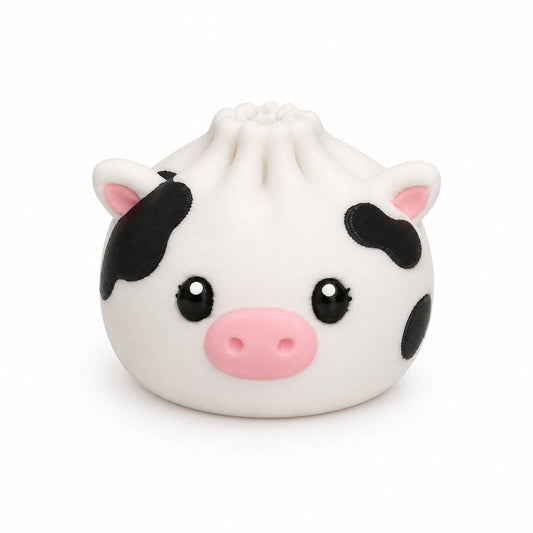 Black and white Cow Dumpling 3D printed bead with pink snout, pink ears, black spots, and cute face by Bailey’s Beads.