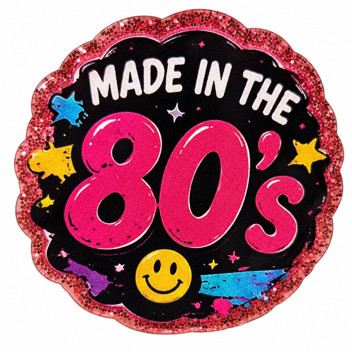Totally 80s acrylic flatback featuring Made in the 80's lettering in hot pink on a black background, yellow smiley face, colorful retro accents, and a sparkling pink glitter border.