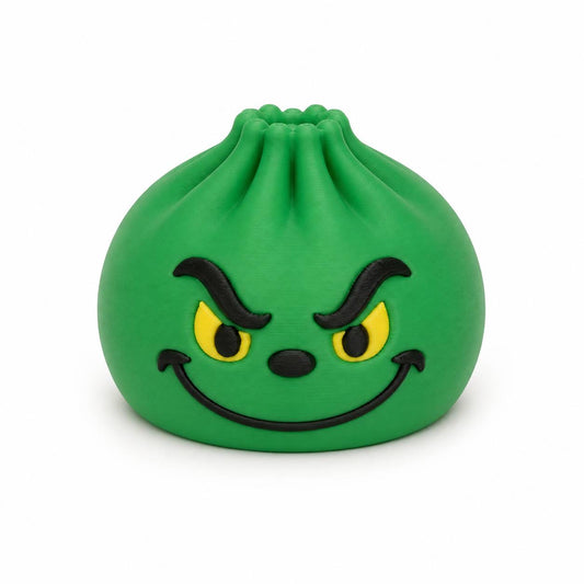 Green Mean One Dumpling 3D printed holiday bead with yellow eyes and mischievous smile by Bailey’s Beads.