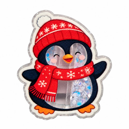Cute winter penguin acrylic flatback with red snowflake hat, matching scarf, orange feet, smiling face and blue iridescent confetti details