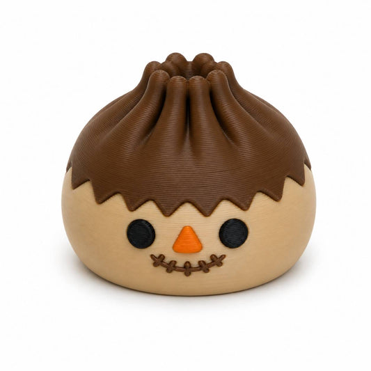 Cute Scarecrow Dumpling 3D printed fall bead with brown hair, orange nose, button eyes, and stitched smile by Bailey’s Beads.