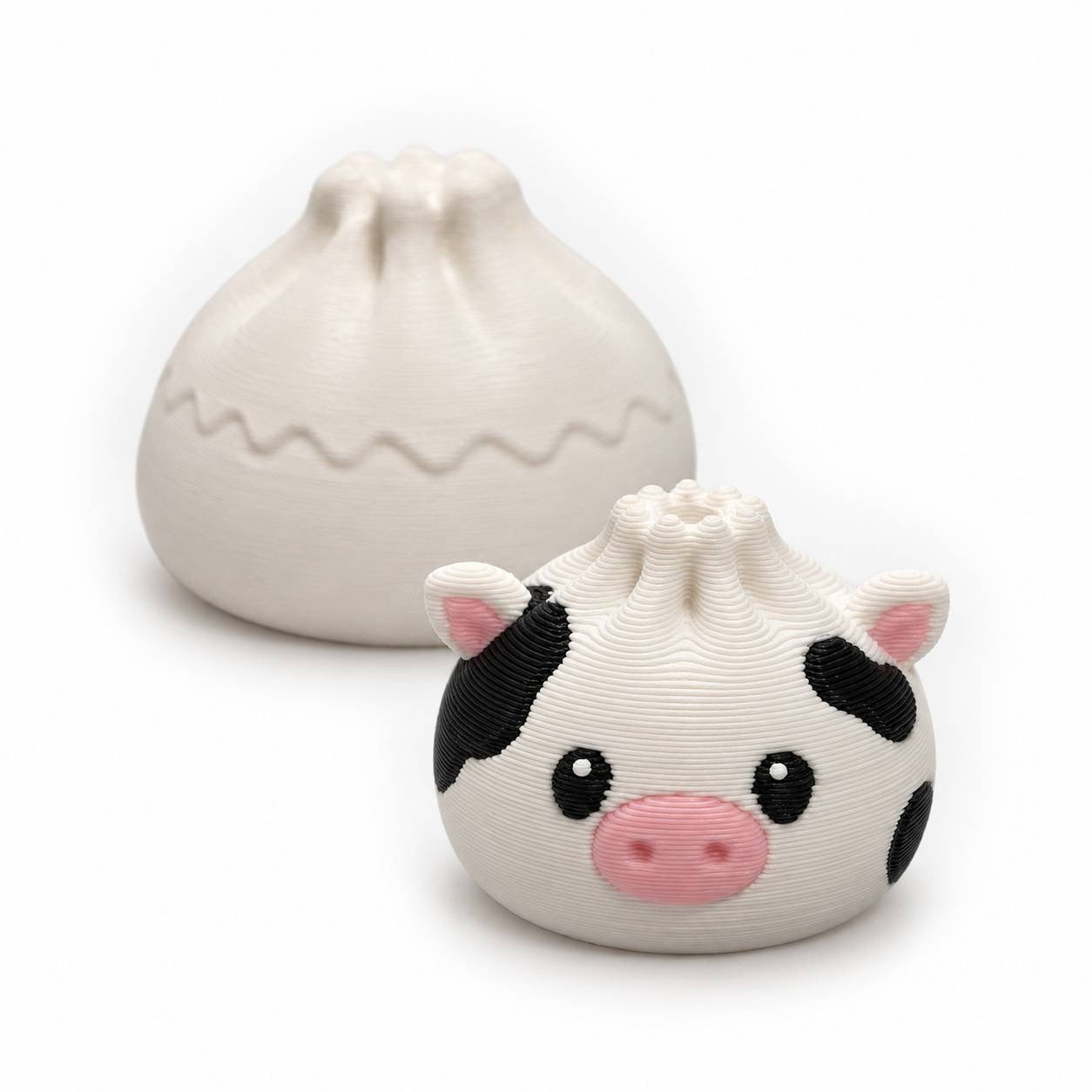 Cow Mini Dumpling 22mm 3D printed bead with black spots and pink snout shown with Original Dumpling for size comparison