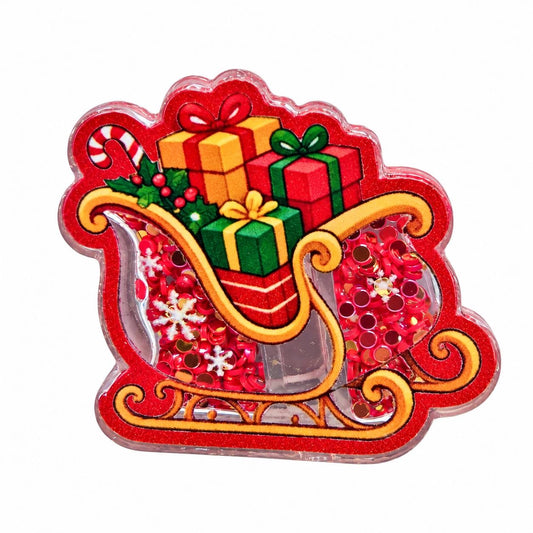 Red and gold Santa sleigh acrylic flatback filled with colorful wrapped Christmas presents, candy cane, holly, red confetti, and white snowflake accents
