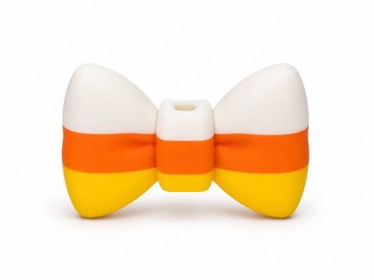 Candy Corn 3D printed bow in white, orange, and yellow by Bailey's Beads for decorating Pen Palz, badge reels, keychains, and Halloween DIY crafts.