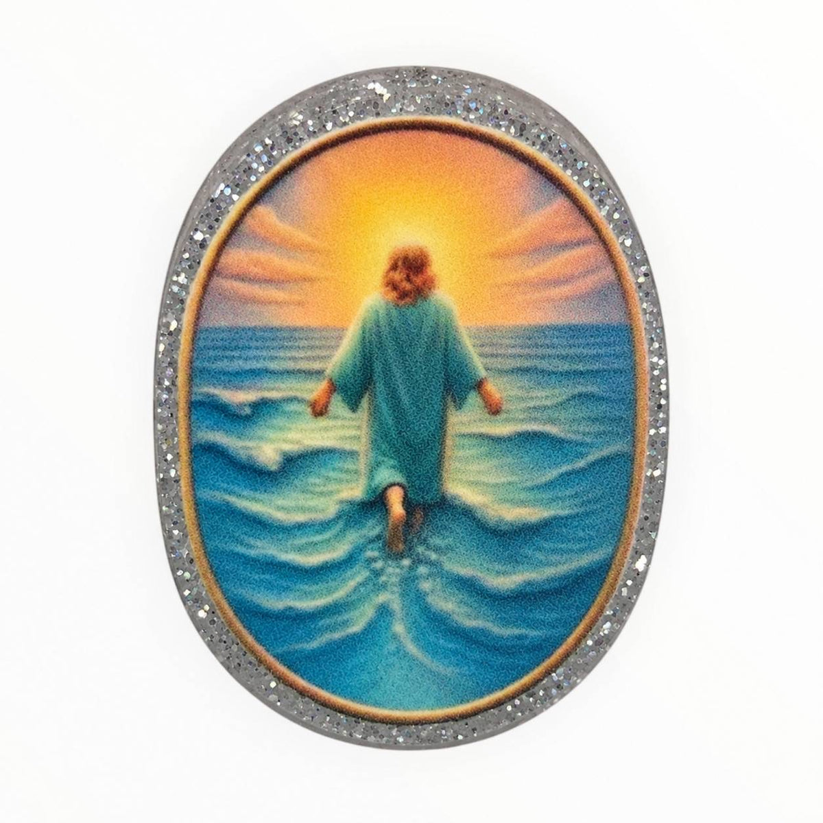 Walking in Faith oval acrylic focal bead featuring Jesus walking on blue ocean waves toward a golden sunset, surrounded by a sparkling silver glitter border.