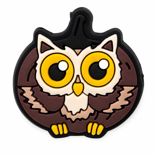 Cute owl pumpkin silicone focal bead featuring a brown owl inside a pumpkin with large yellow eyes