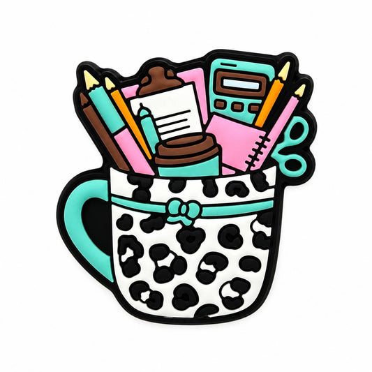 White leopard print coffee mug silicone focal bead filled with office and crafting supplies, including pencils, scissors, calculator, clipboard, and notebook by Bailey's Beads.