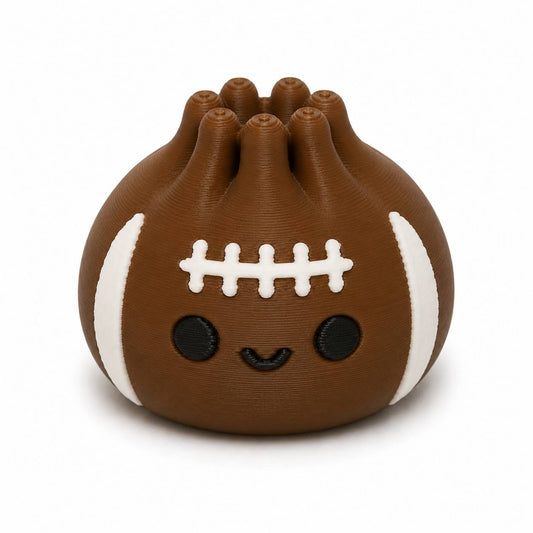 Brown Blitz Dumpling Pen Palz 3D printed football-inspired bead with classic white football stripes, stitched laces, and a kawaii smile by Bailey's Beads for beadable pens, keychains, badge reels, and DIY crafts.