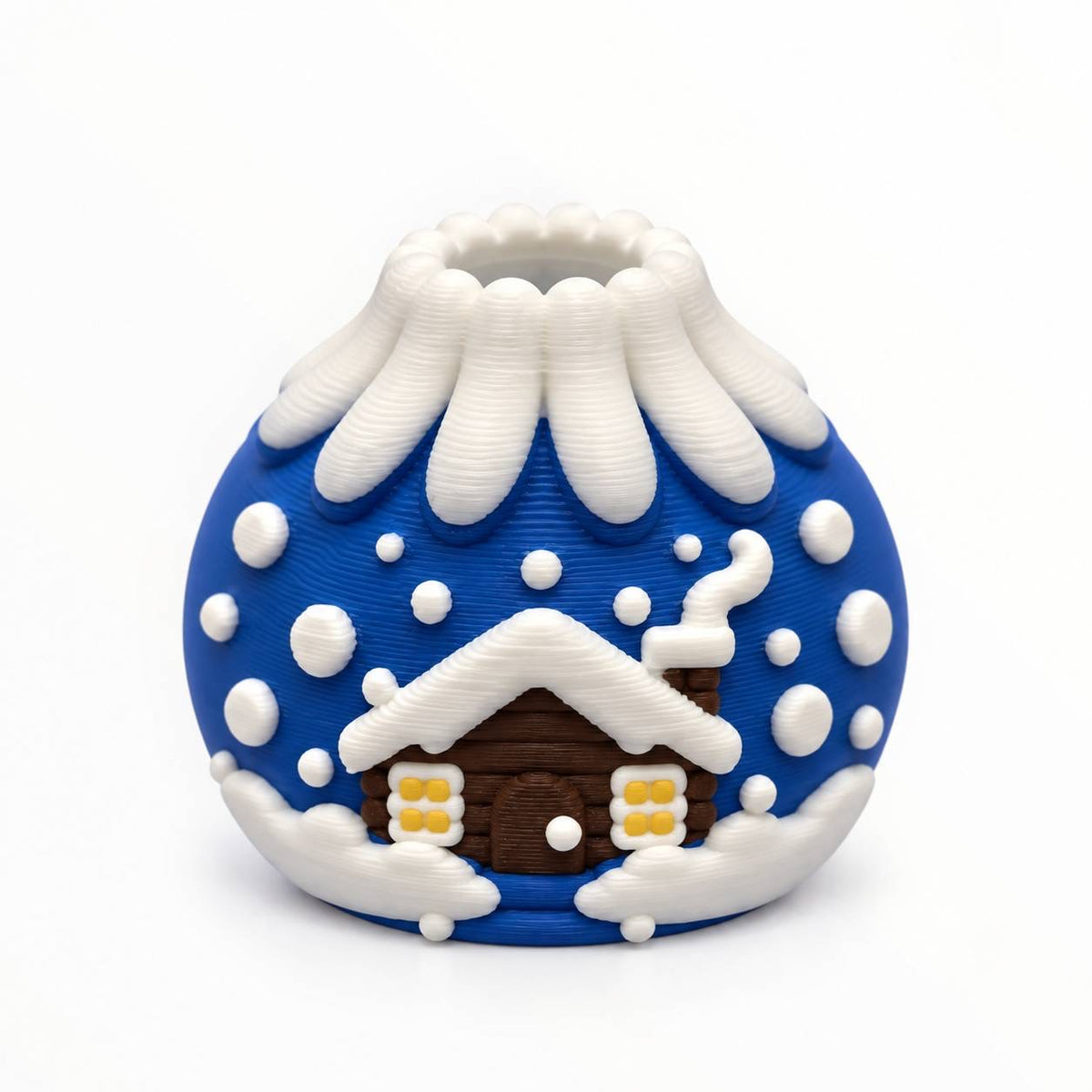 Snowfall Hideaway 3D printed winter bead featuring a brown log cabin with glowing yellow windows, white snow-covered roof and royal blue snowy background.