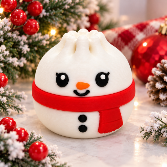 Cute 3D printed snowman dumpling focal bead with red scarf, carrot nose and black buttons in a festive Christmas setting